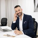 Smiling European Adult Guy In Suit With Beard Works On Laptop, C